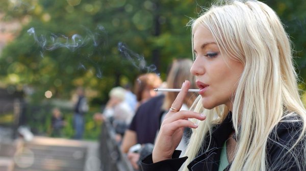 женщина курит на улице